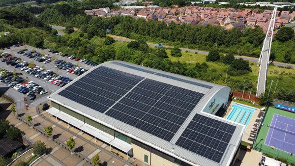 Solar panels on the roof of a David Lloyd leisure centre